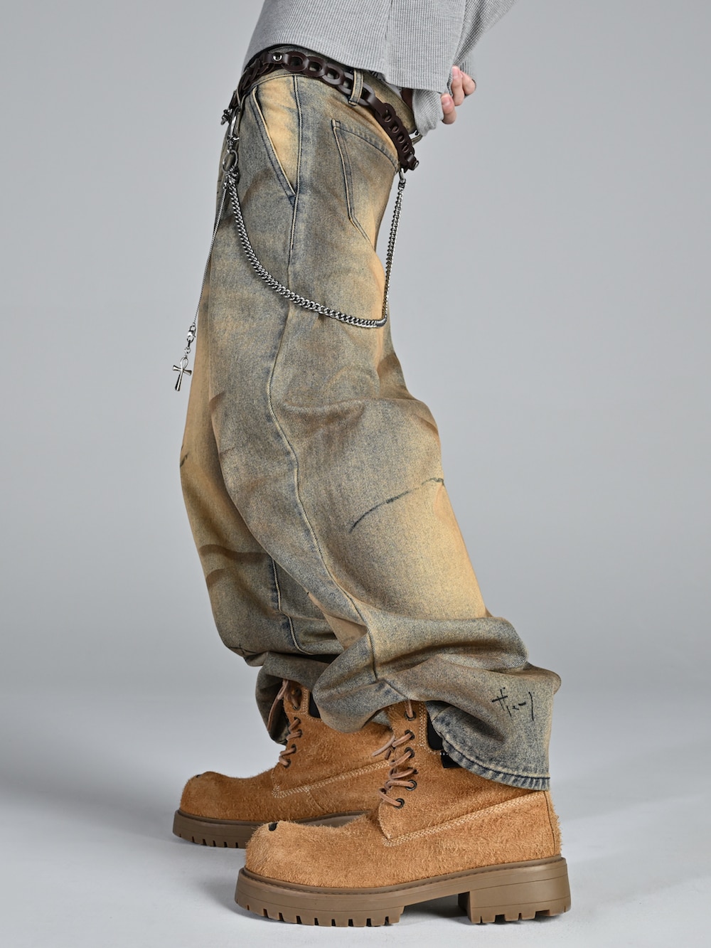 ベージュ系のブーツ、ブラック系のジャケット/アウター、ブルー系のデニムパンツを着用したメンズの冬コーディネートの3枚目の写真