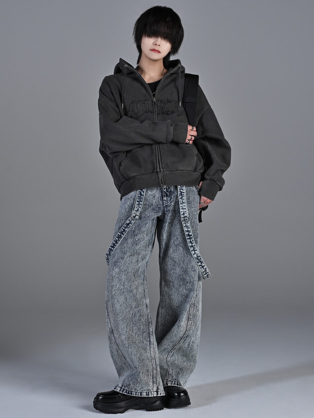 ブラック系のショルダーバッグ、ブラック系のスニーカー、グレー系のパーカーを着用したメンズの冬コーディネートの2枚目の写真