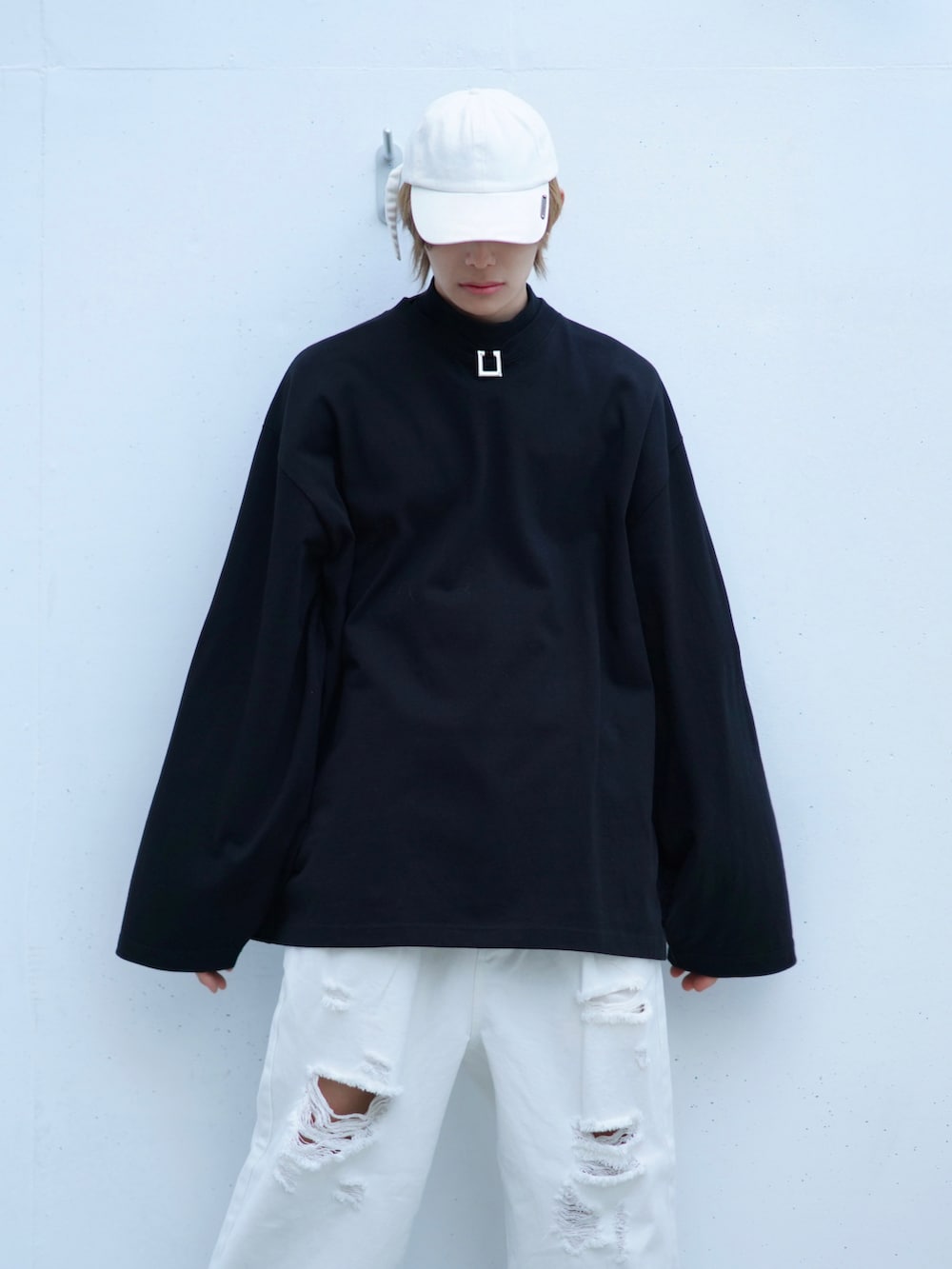 ホワイト系のデニムパンツ、ブラック系のTシャツ/カットソー、ブラック系のスニーカーを着用したメンズの夏コーディネートの2枚目の写真