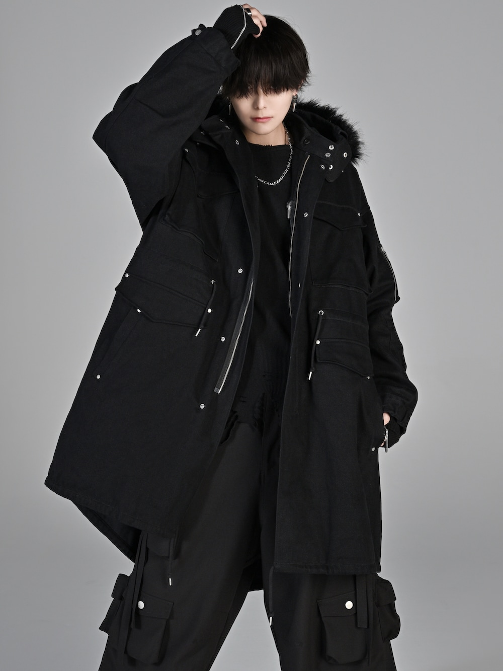 ブラック系のカーゴパンツ、ブラック系のTシャツ/カットソー、ブラック系のモッズコートを着用したメンズの秋コーディネートの2枚目の写真