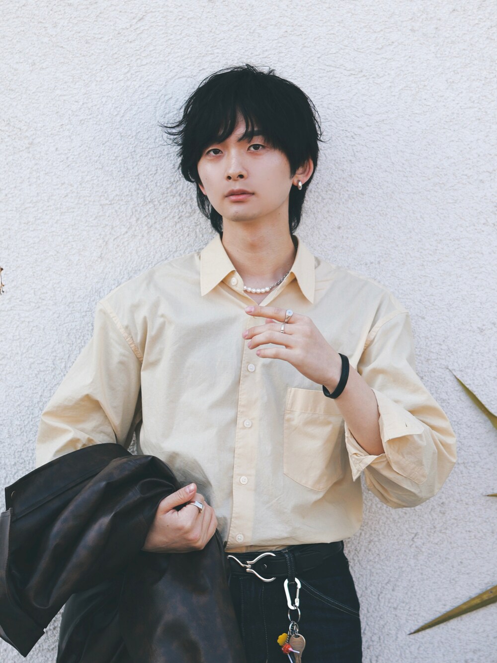 ブラウン系のブルゾン、イエロー系のシャツ/ブラウス、ブルー系のデニムパンツを着用したメンズの春コーディネートの5枚目の写真