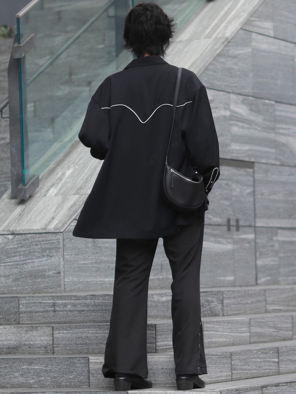 ブラック系のシャツ/ブラウス、ブラック系のショルダーバッグ、シルバー系のネックレスを着用したメンズの春コーディネートの3枚目の写真