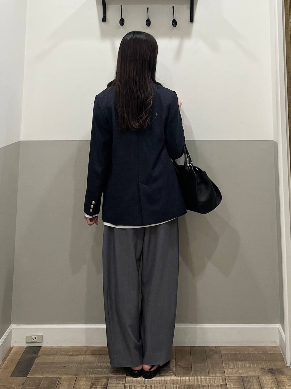 グレー系のスラックス、ブルー系のテーラードジャケット、ホワイト系のTシャツ/カットソーを着用したレディースの冬コーディネートの8枚目の写真