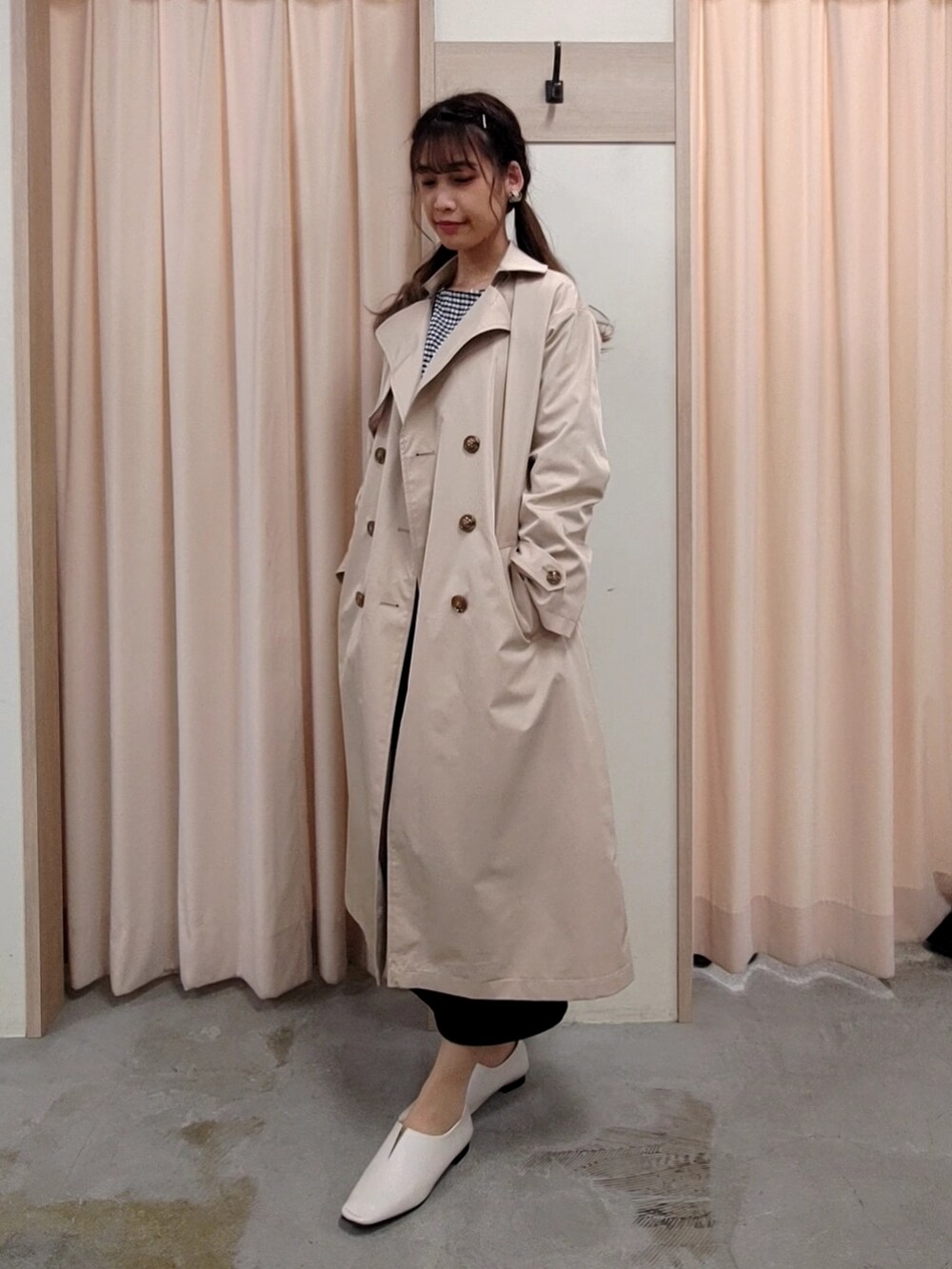 ホワイト系のその他シューズ、ベージュ系のトレンチコート、ブラック系のTシャツ/カットソーを着用したレディースの春コーディネートの3枚目の写真