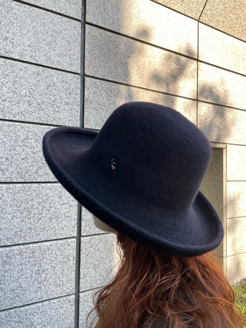 ブルー系のハットを着用したレディースの冬コーディネートの2枚目の写真