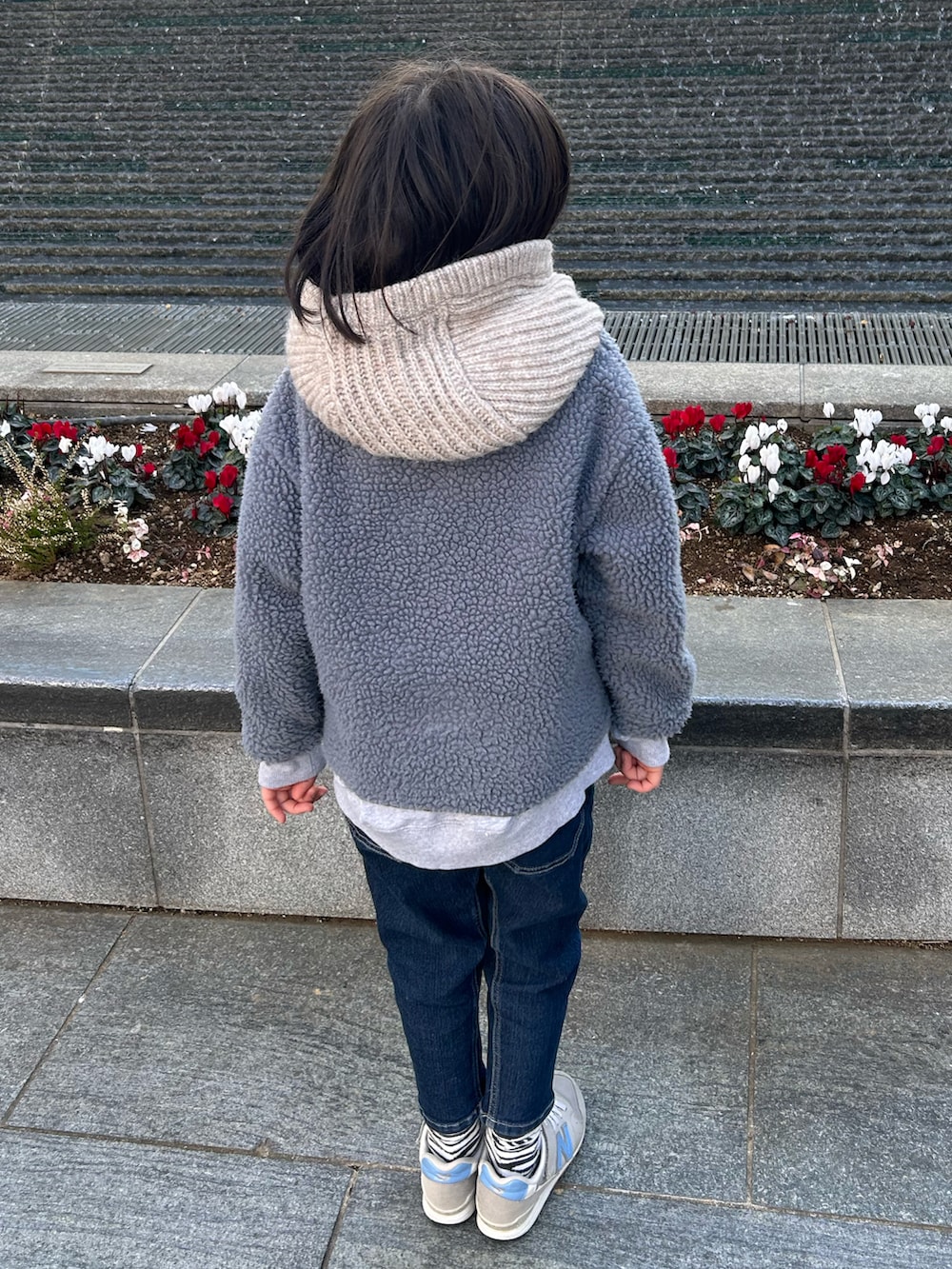 ブルー系のノーカラージャケット、グレー系のスウェット、ブルー系のデニムパンツを着用したキッズの冬コーディネートの2枚目の写真