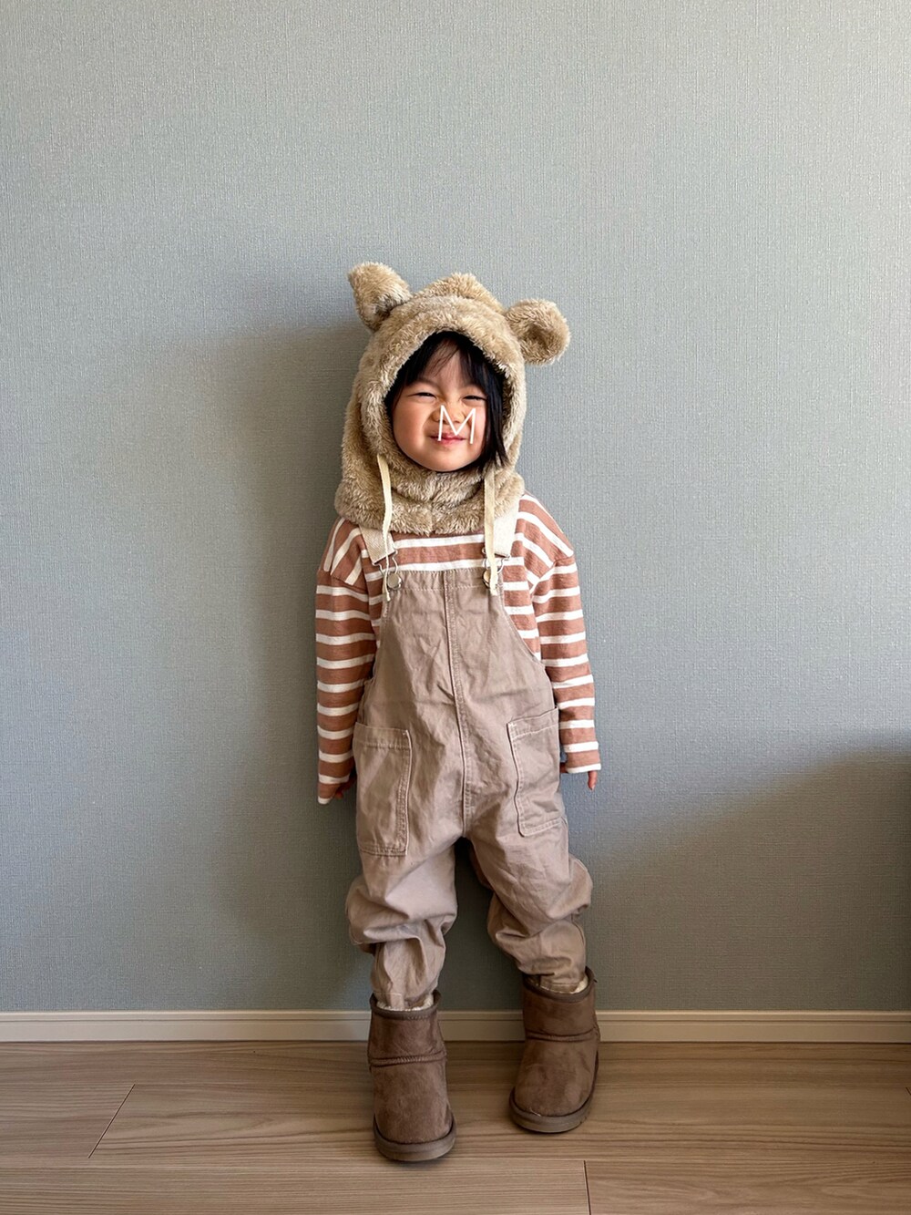 ブラック系のワンピース、ベージュ系のサロペット/オーバーオール、グレー系のブーツを着用したキッズの冬コーディネートの3枚目の写真