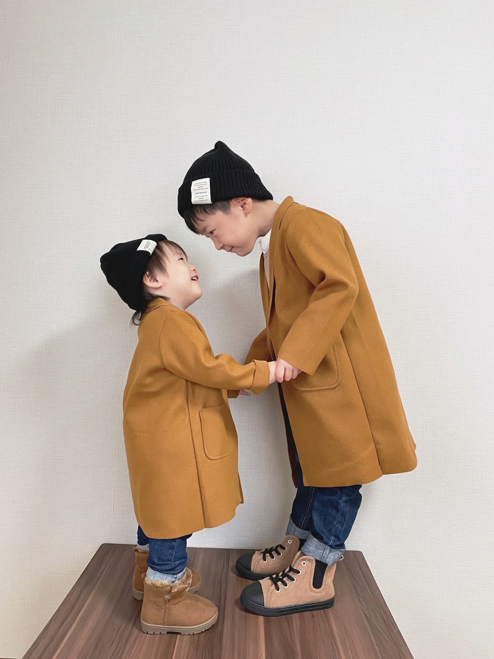 ブラウン系のジャケット/アウター、イエロー系のTシャツ/カットソー、ブルー系のデニムパンツを着用したキッズの秋コーディネートの2枚目の写真