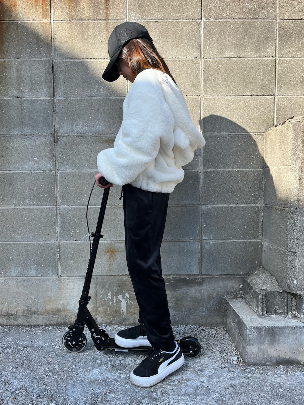 ホワイト系のジャケット/アウター、ブラック系のパンツ、ブラック系のスニーカーを着用したキッズの冬コーディネートの3枚目の写真