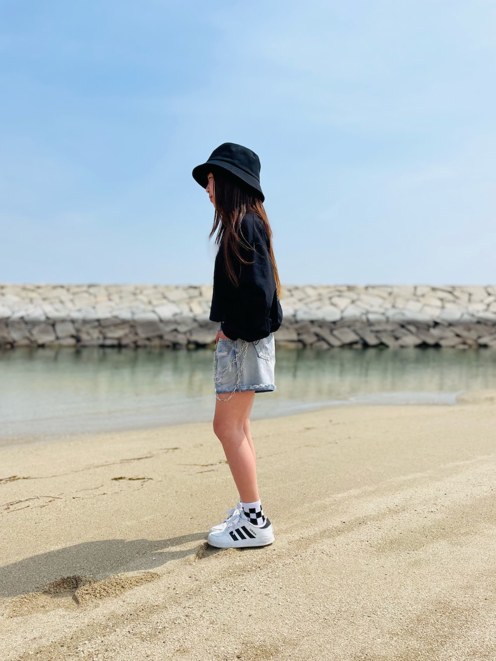 ブラック系のTシャツ/カットソー、ブルー系のパンツ、ホワイト系のスニーカーを着用したキッズの春コーディネートの3枚目の写真