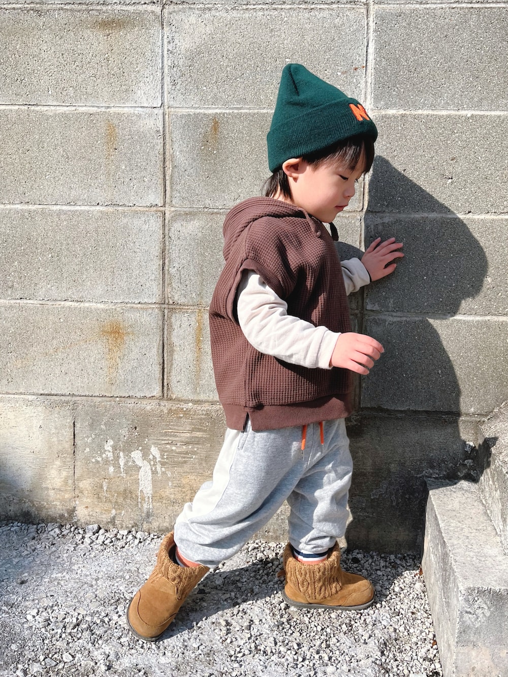 ブラウン系のパーカー、グレー系のスウェットパンツ、ブラウン系のブーツを着用したキッズの冬コーディネートの2枚目の写真