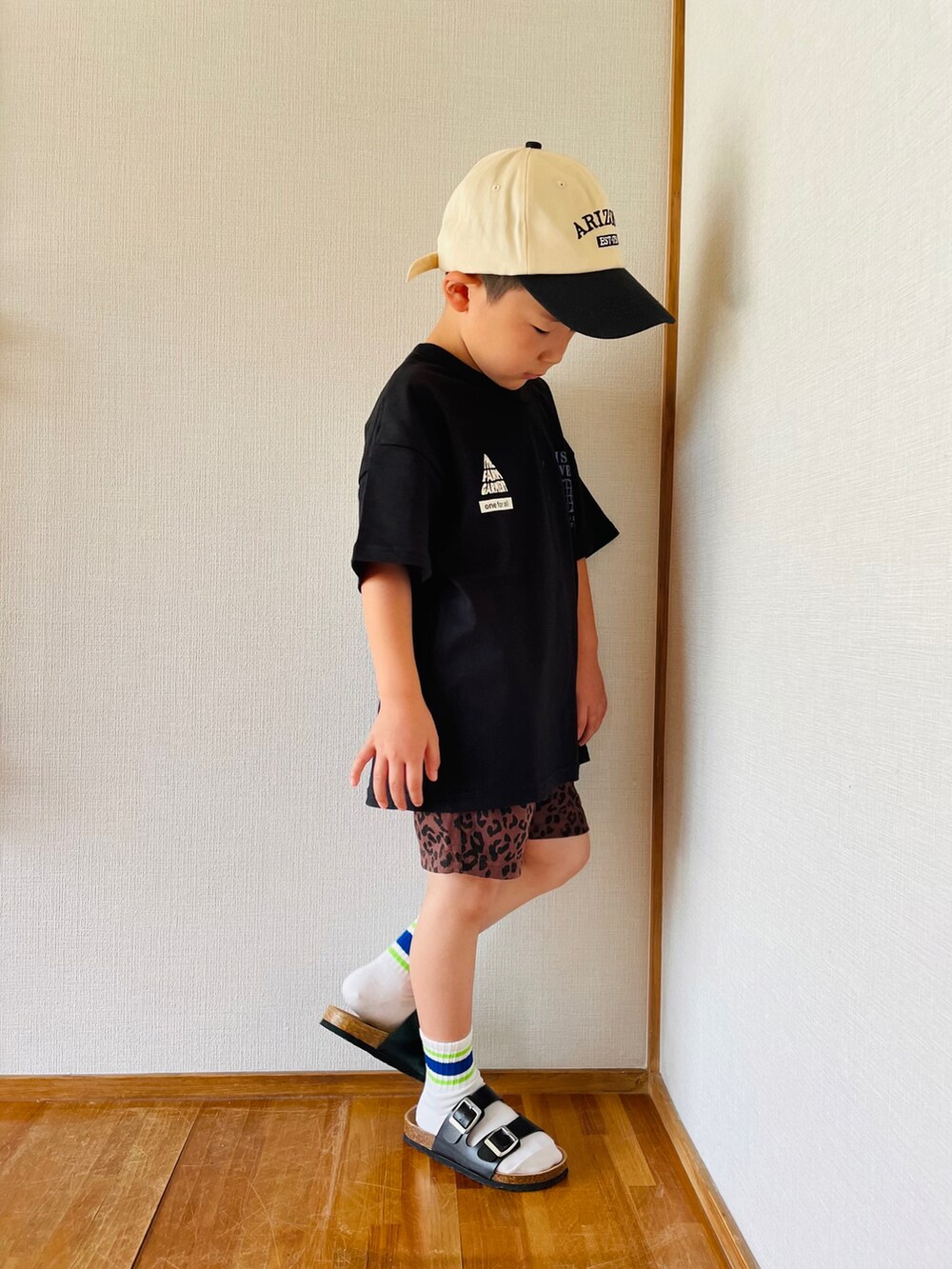 ブラック系のTシャツ/カットソー、ブラウン系のパンツ、ブラック系のサンダルを着用したキッズの夏コーディネートの3枚目の写真