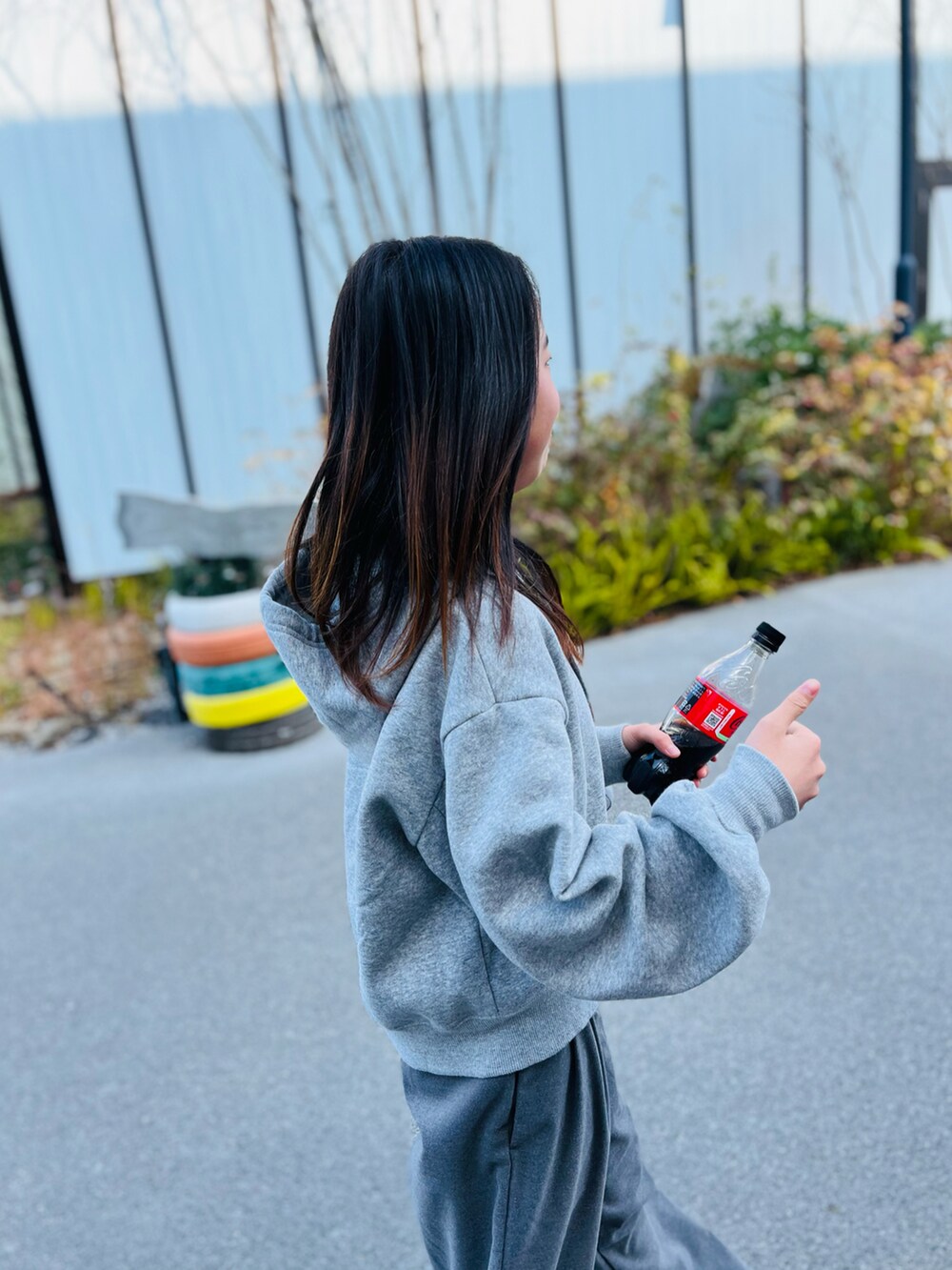 グレー系のパンツ、パープル系のバックパック/リュック、ホワイト系のスニーカーを着用したキッズの冬コーディネートの4枚目の写真