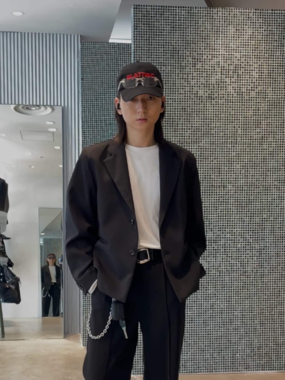 ブラック系のテーラードジャケット、ブラック系のスラックス、ホワイト系のTシャツ/カットソーを着用したメンズの春コーディネートの3枚目の写真