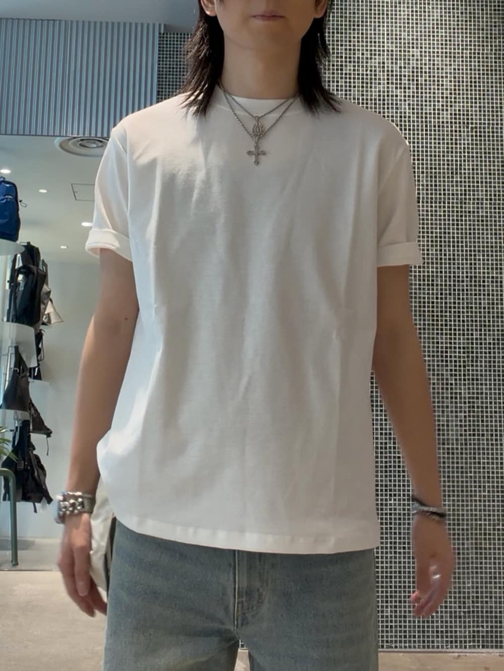 ホワイト系のTシャツ/カットソー、ブルー系のデニムパンツ、ブルー系のキャップを着用したメンズの夏コーディネートの3枚目の写真