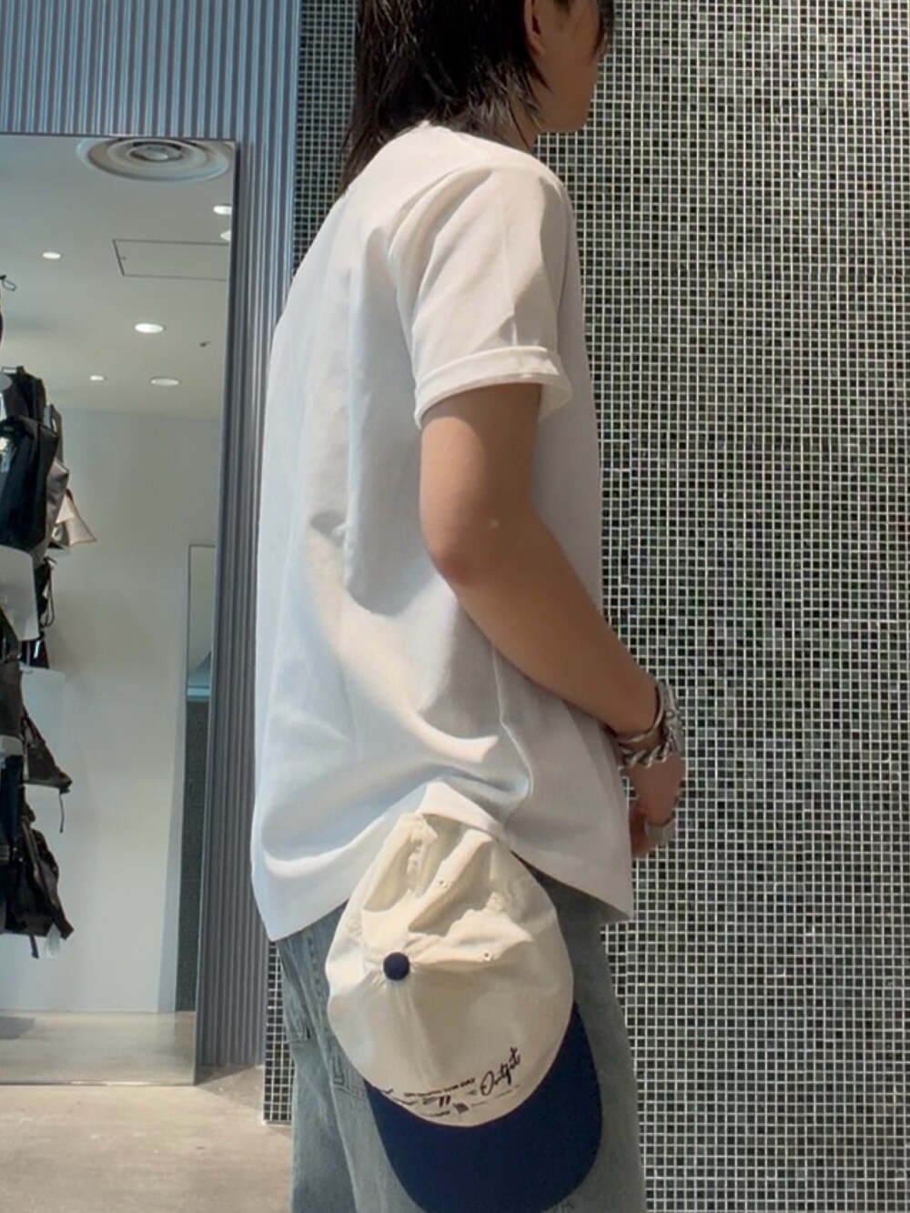 ホワイト系のTシャツ/カットソー、ブルー系のデニムパンツ、ブルー系のキャップを着用したメンズの夏コーディネートの4枚目の写真