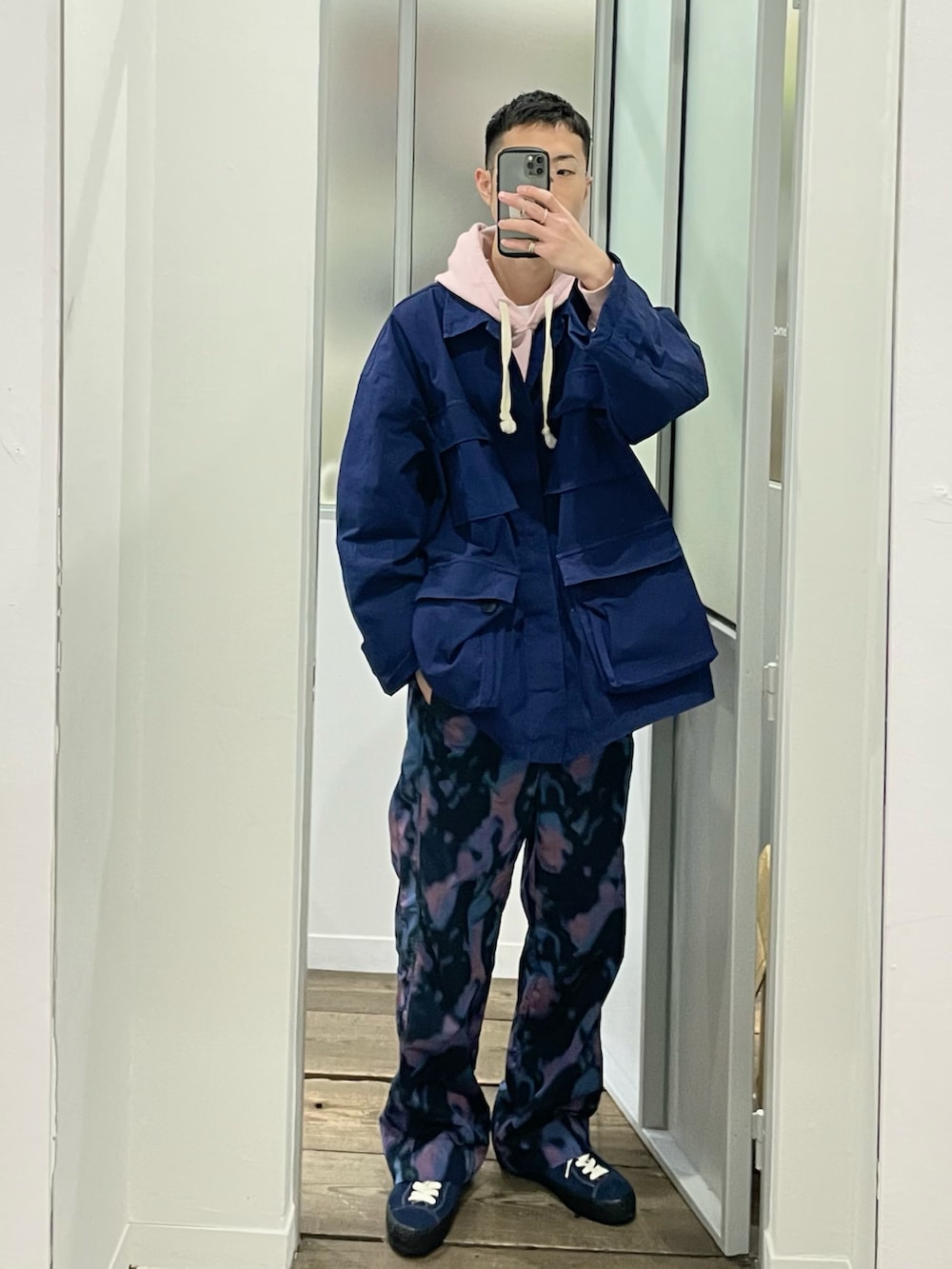 その他のその他パンツ、ブルー系のスニーカー、ピンク系のパーカーを着用したメンズの春コーディネートの2枚目の写真