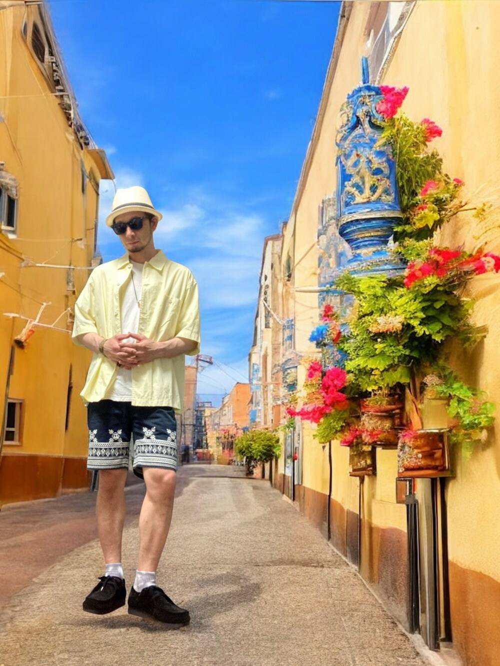 ブルー系のパンツ、ブラック系のモカシン/デッキシューズ、イエロー系のシャツ/ブラウスを着用したメンズの夏コーディネートの3枚目の写真