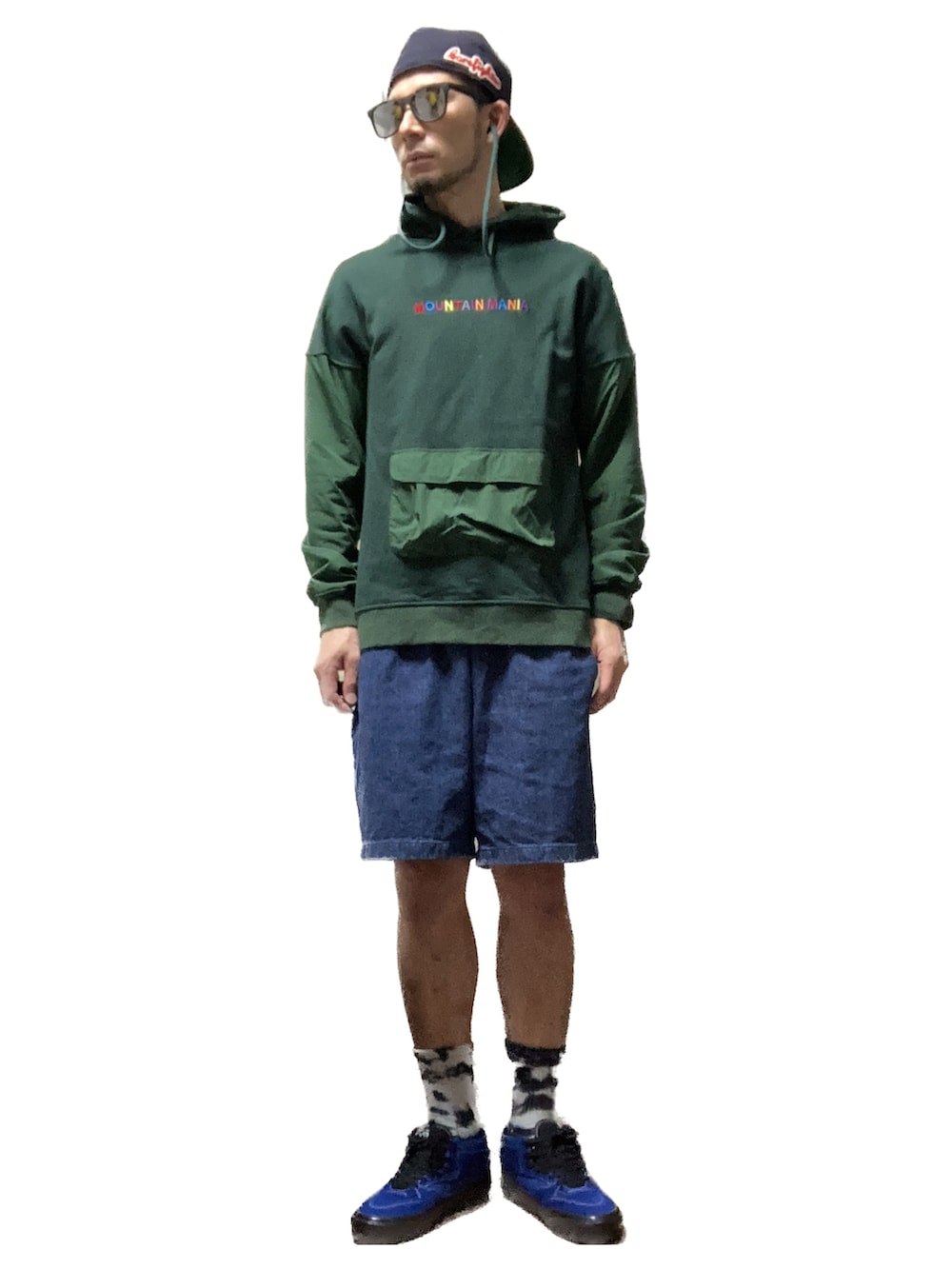 グリーン系のパーカー、ブルー系のデニムパンツ、ブルー系のスニーカーを着用したメンズの秋コーディネートの2枚目の写真