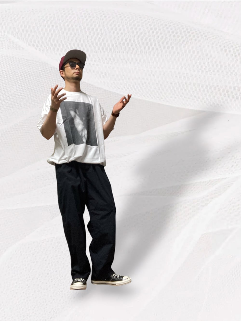 ブラック系のスニーカー、ホワイト系のTシャツ/カットソー、ブラック系のスーツパンツを着用したメンズの夏コーディネートの3枚目の写真