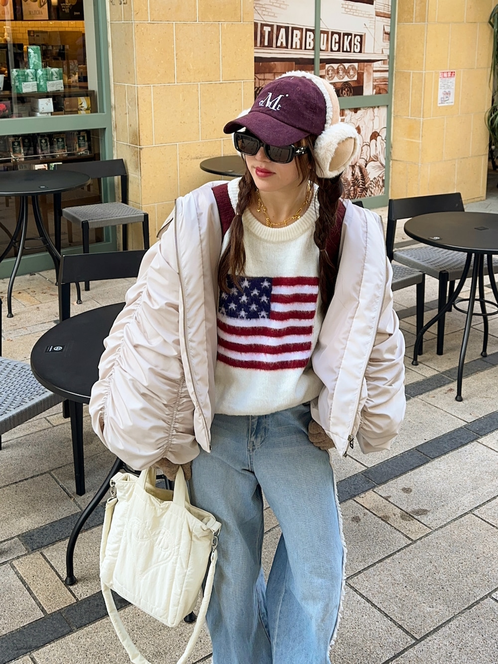 ホワイト系のニット/セーター、ブルー系のデニムパンツを着用したレディースの冬コーディネートの2枚目の写真