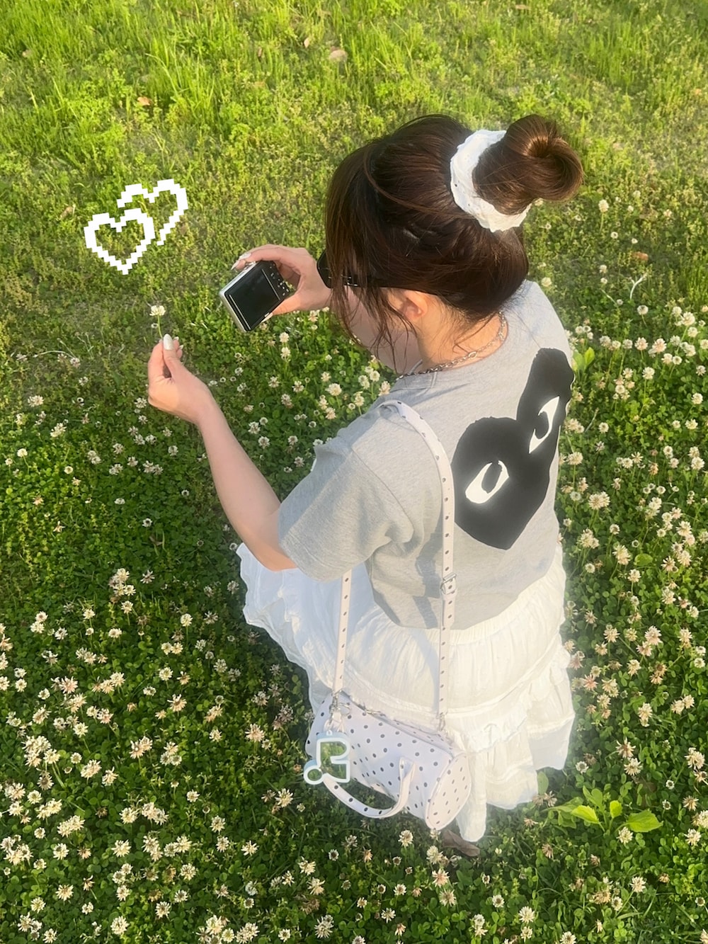 ホワイト系のスニーカー、ホワイト系のスカート、グレー系のTシャツ/カットソーを着用したレディースの春コーディネートの2枚目の写真