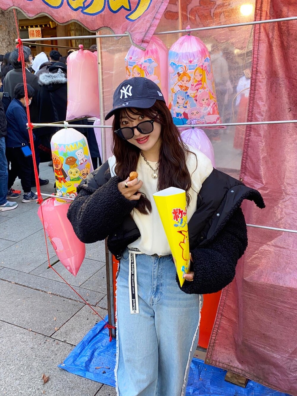 ブルー系のデニムパンツ、ホワイト系のスウェット、グレー系のスニーカーを着用したレディースの冬コーディネートの4枚目の写真