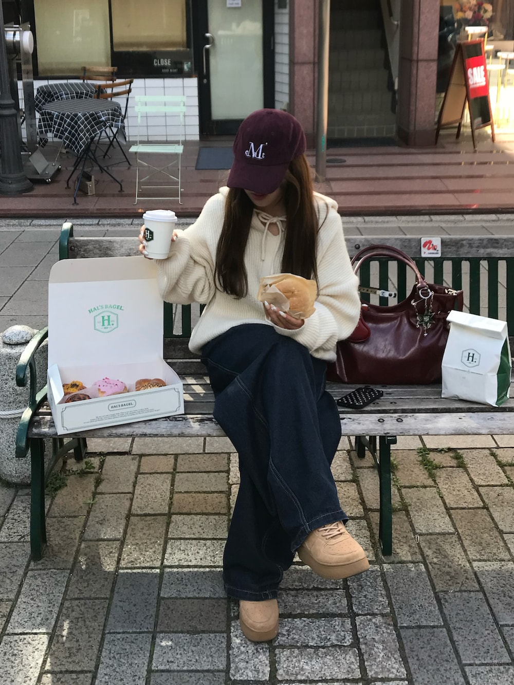 ブルー系のデニムパンツ、ホワイト系のトップス、レッド系のバッグを着用したレディースの冬コーディネートの4枚目の写真