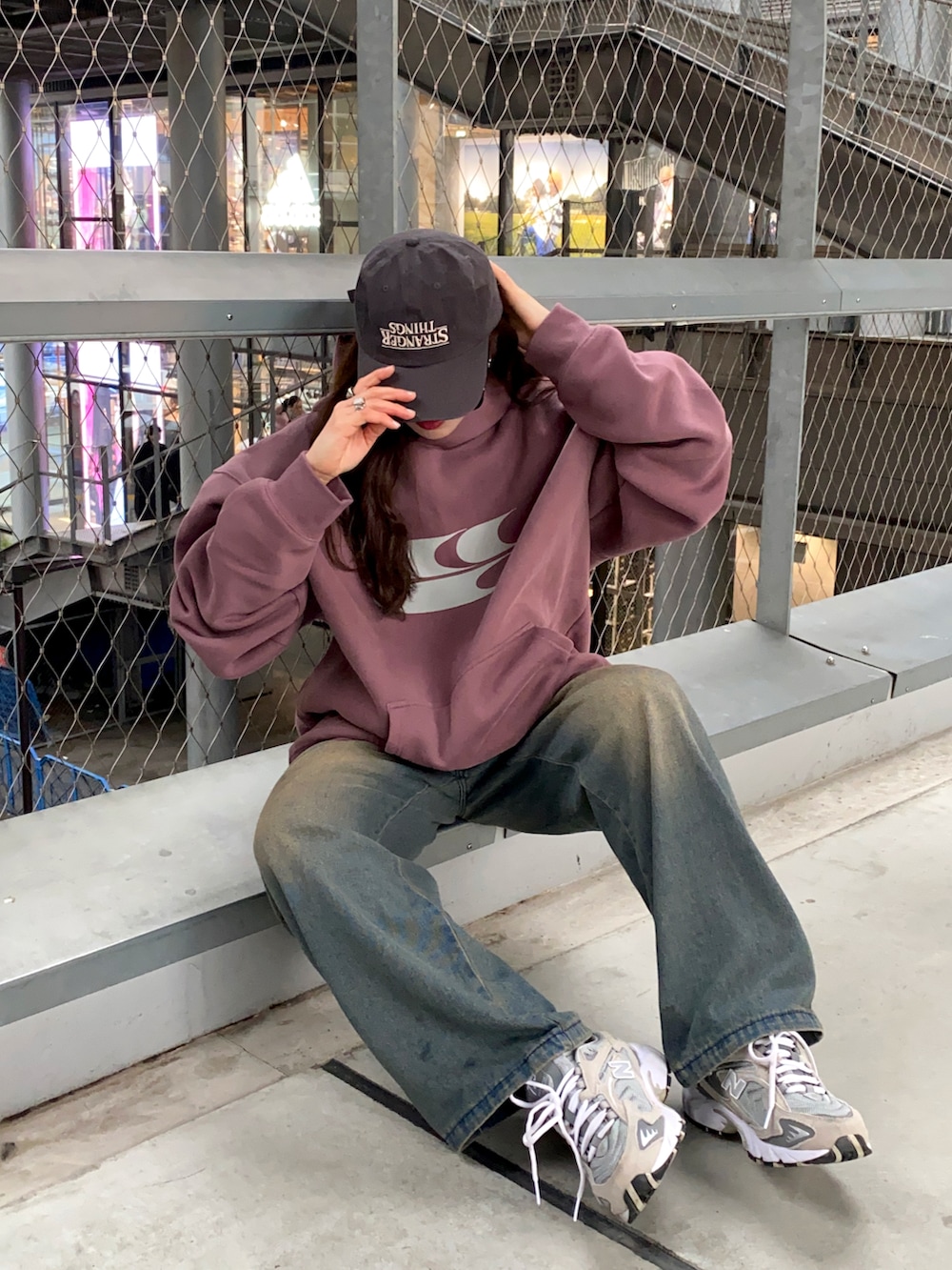 ブルー系のデニムジャケット、グレー系のスニーカー、グレー系のキャップを着用したレディースの冬コーディネートの3枚目の写真