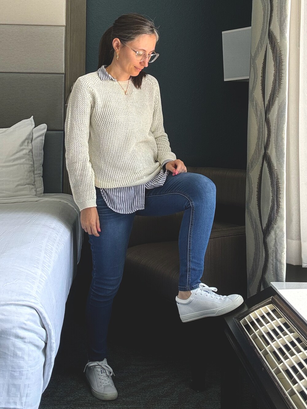 ブルー系のデニムパンツ、ホワイト系のスニーカー、ブルー系のシャツ/ブラウスを着用したレディースの春コーディネートの2枚目の写真