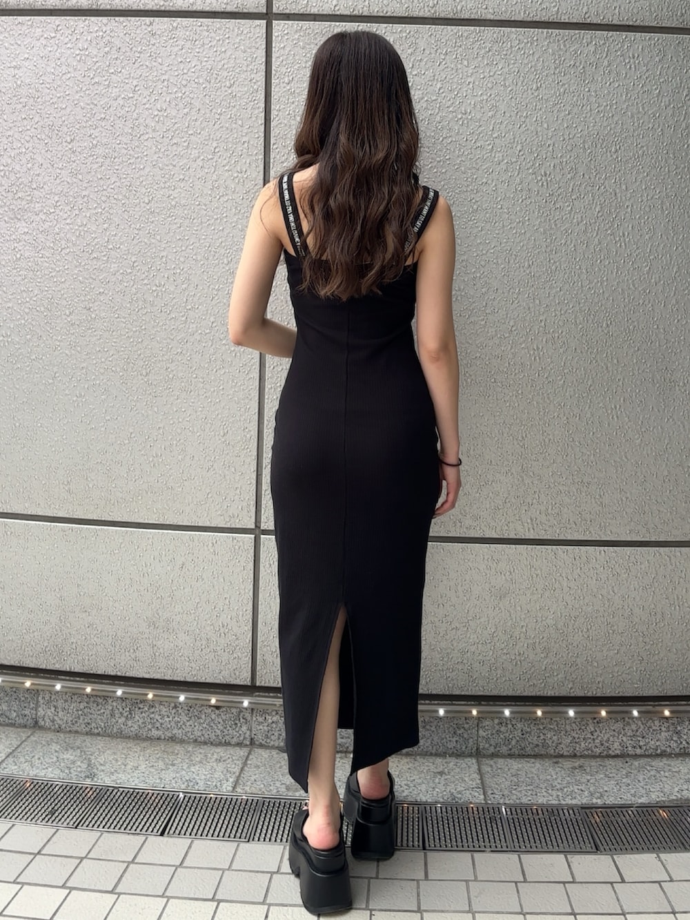 ブラック系のワンピース、ブラック系のサンダルを着用したレディースの春コーディネートの3枚目の写真