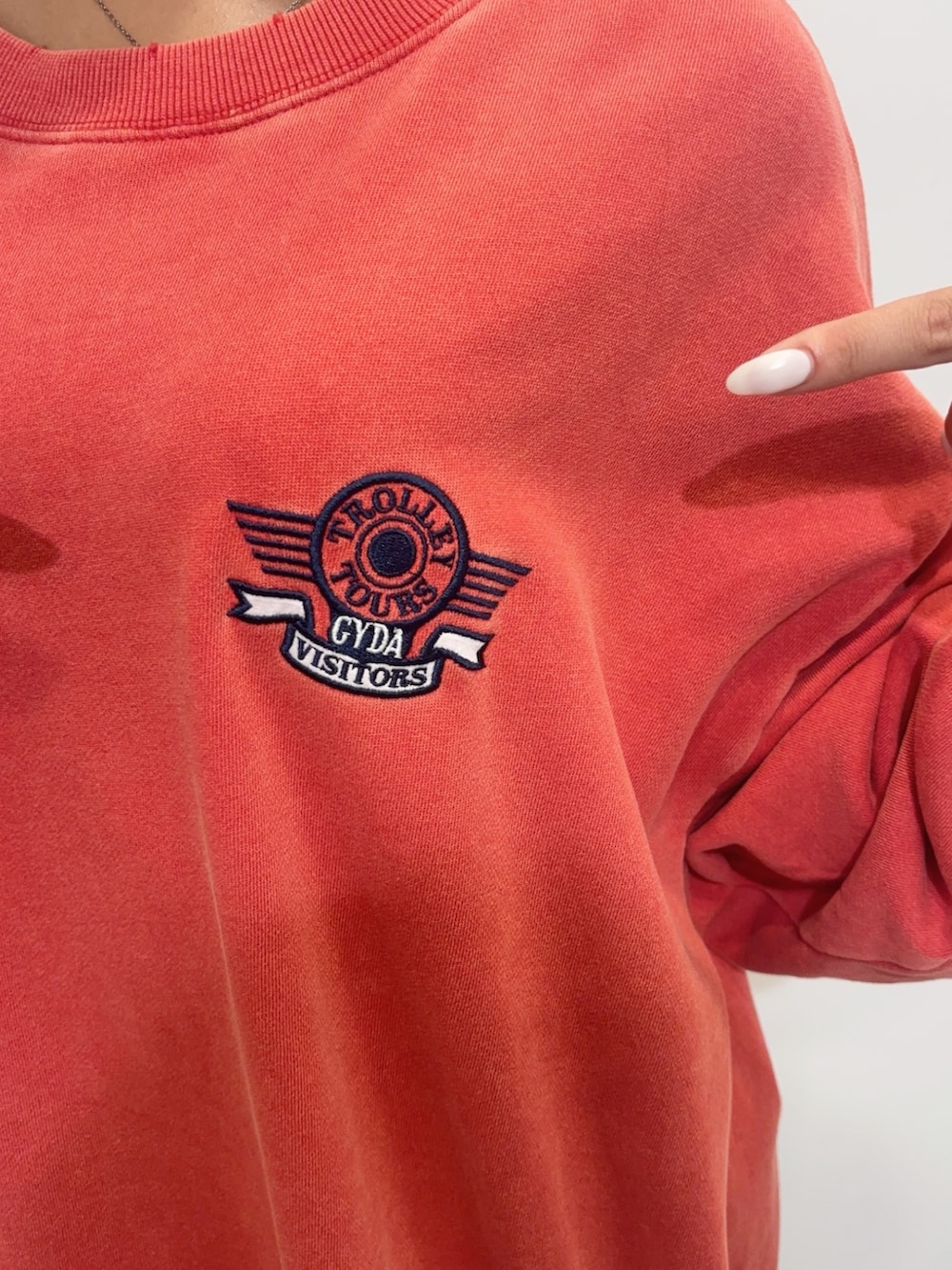 レッド系のスウェット、グリーン系のその他パンツ、ブラック系のブーツを着用したレディースの夏コーディネートの5枚目の写真