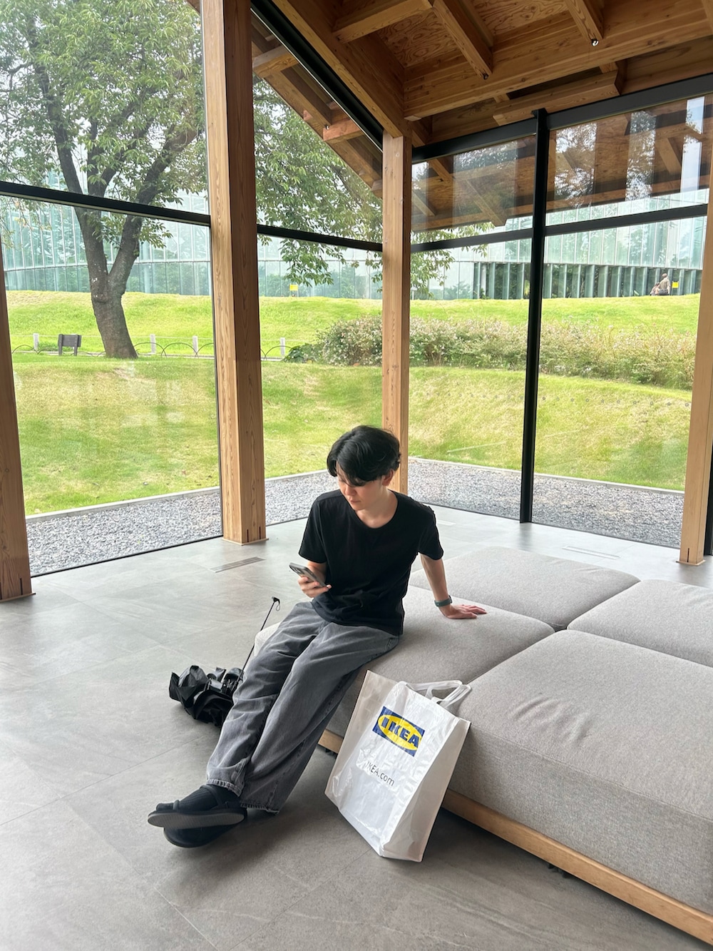 ブラック系のTシャツ/カットソー、ホワイト系のバッグを着用したメンズの春コーディネートの2枚目の写真