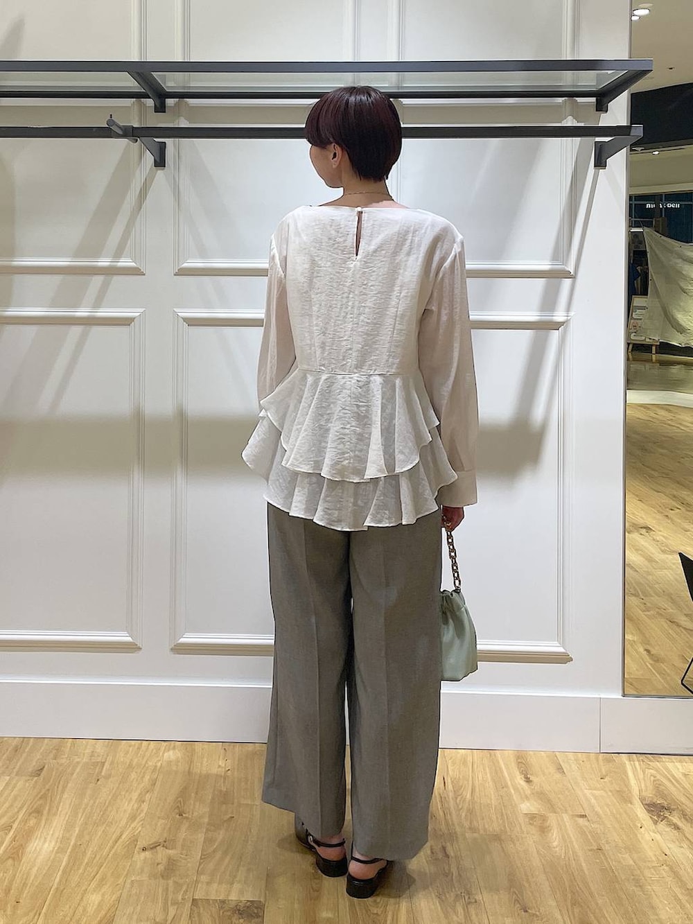 グリーン系のショルダーバッグ、ブラック系のその他パンツ、ホワイト系のシャツ/ブラウスを着用したレディースの春コーディネートの4枚目の写真