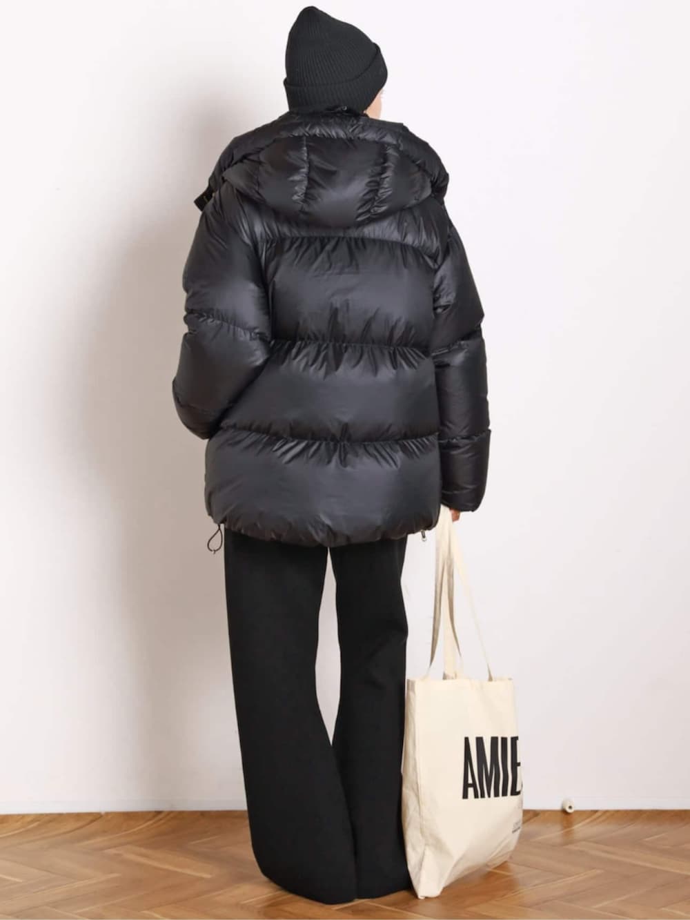 ホワイト系のTシャツ/カットソー、ブラック系のその他パンツ、ブラック系のダウンジャケット/コートを着用したレディースの秋コーディネートの3枚目の写真