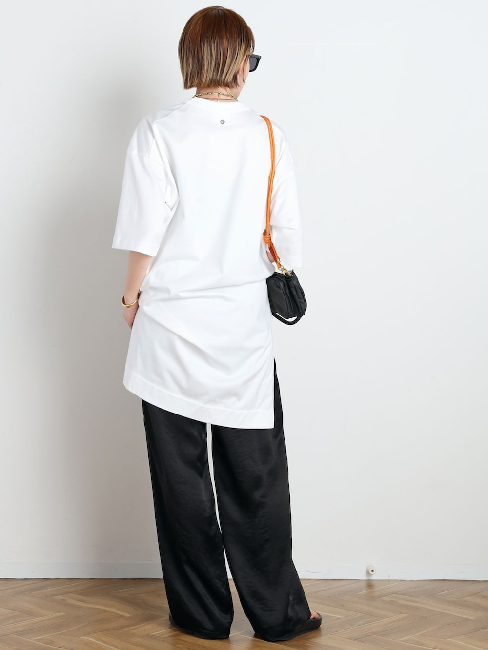 ブラック系のその他パンツ、ホワイト系のTシャツ/カットソー、ブラック系のショルダーバッグを着用したレディースの春コーディネートの3枚目の写真