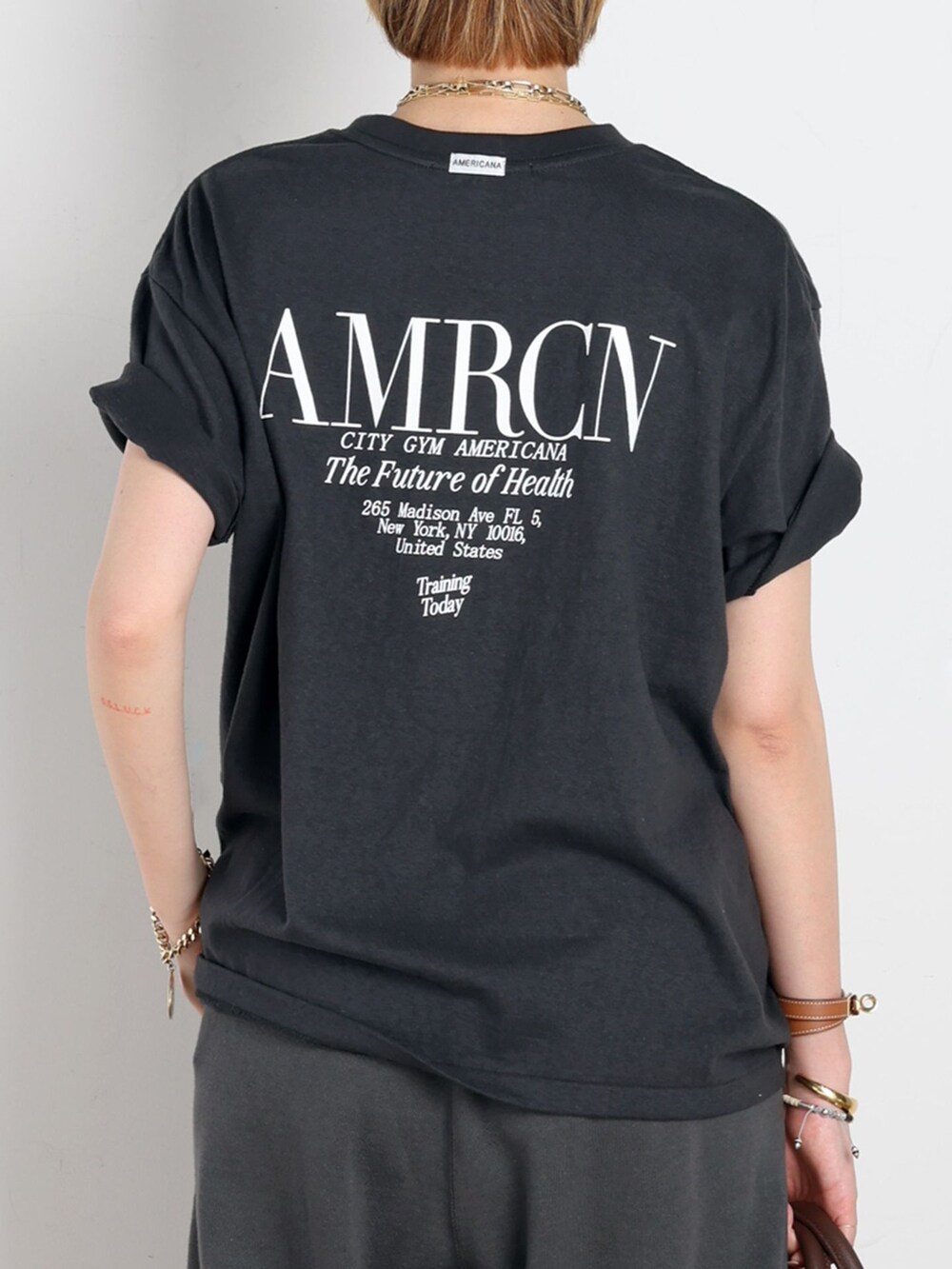 ブラック系のスウェットパンツ、ブラック系のTシャツ/カットソー、ゴールド系のネックレスを着用したレディースの春コーディネートの6枚目の写真