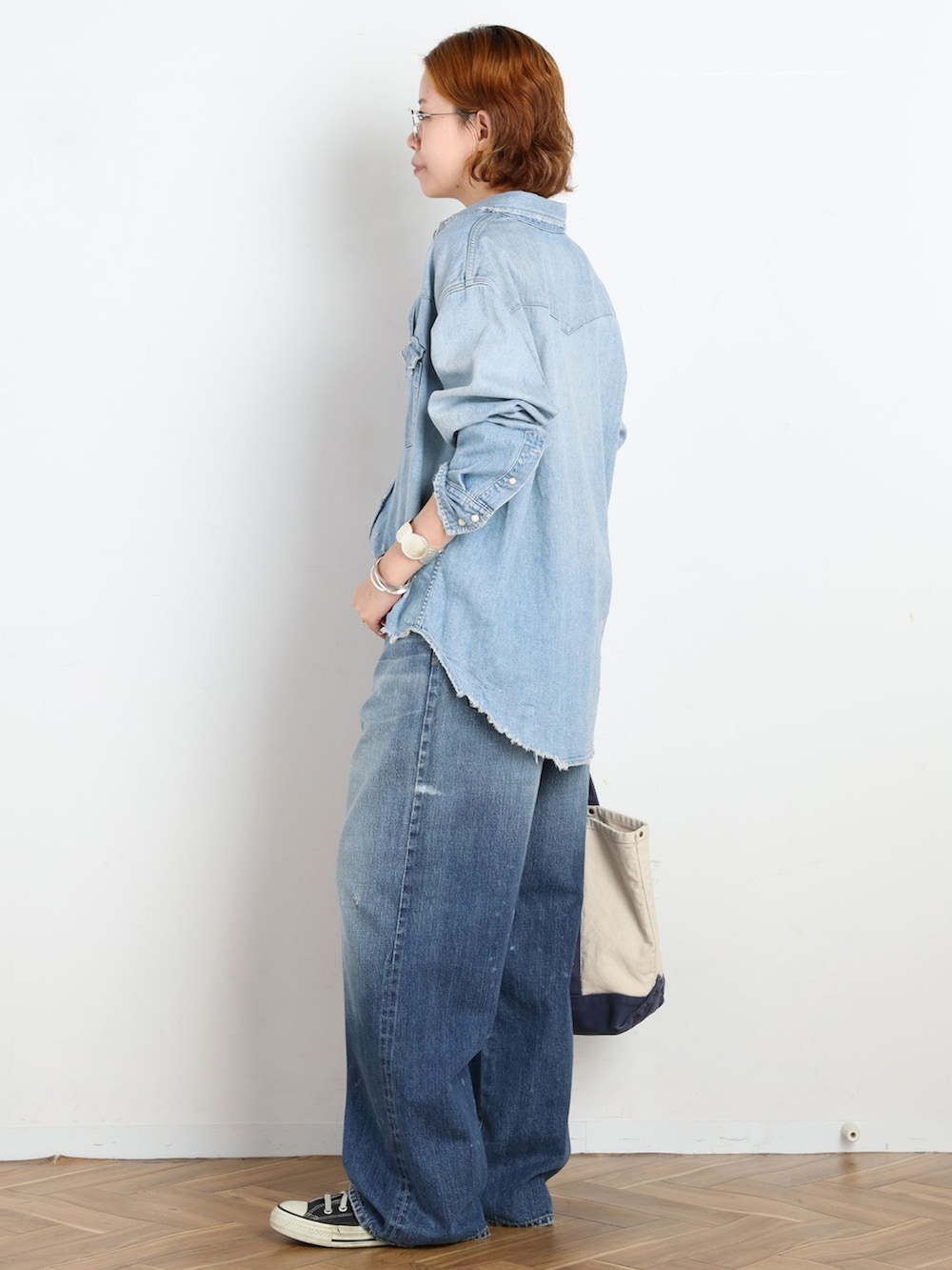 ブルー系のデニムパンツ、ブルー系のシャツ/ブラウス、ブルー系のトートバッグを着用したレディースの夏コーディネートの3枚目の写真
