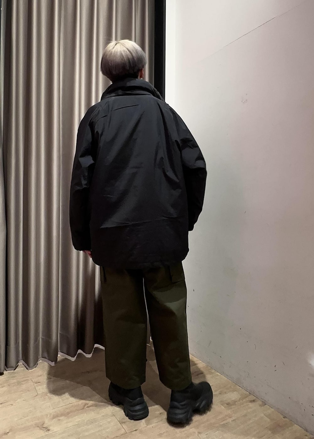 ブラック系のニット/セーター、グリーン系のカーゴパンツ、ブラック系のブルゾンを着用したメンズの冬コーディネートの3枚目の写真