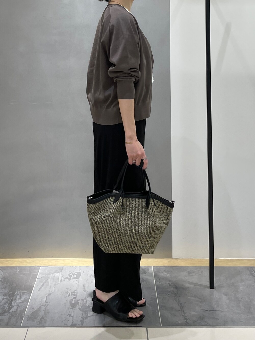 ブラック系のその他パンツ、ブラック系のトートバッグ、ブラウン系のカーディガン/ボレロを着用したレディースの春コーディネートの6枚目の写真