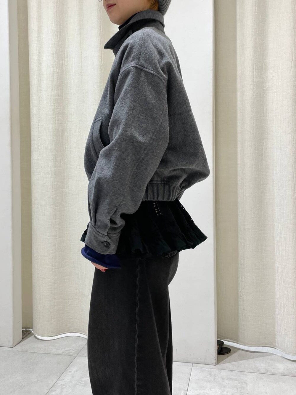 ブラック系のデニムパンツ、グレー系のブルゾン、ブルー系のニット/セーターを着用したレディースの冬コーディネートの5枚目の写真