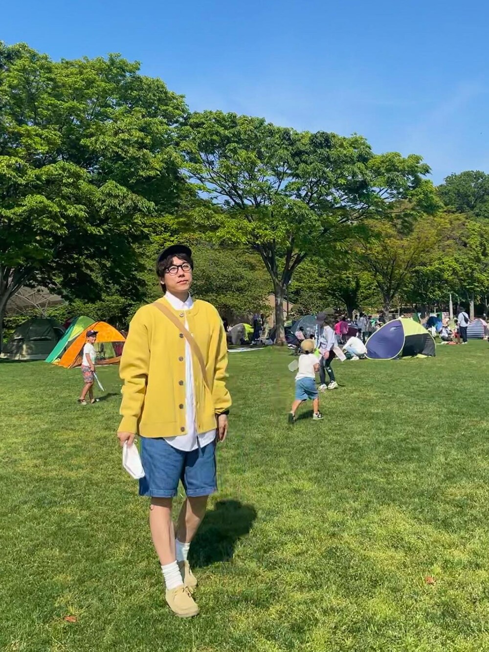 ブルー系のその他パンツ、グリーン系のショルダーバッグ、ホワイト系のシャツ/ブラウスを着用したメンズの春コーディネートの2枚目の写真