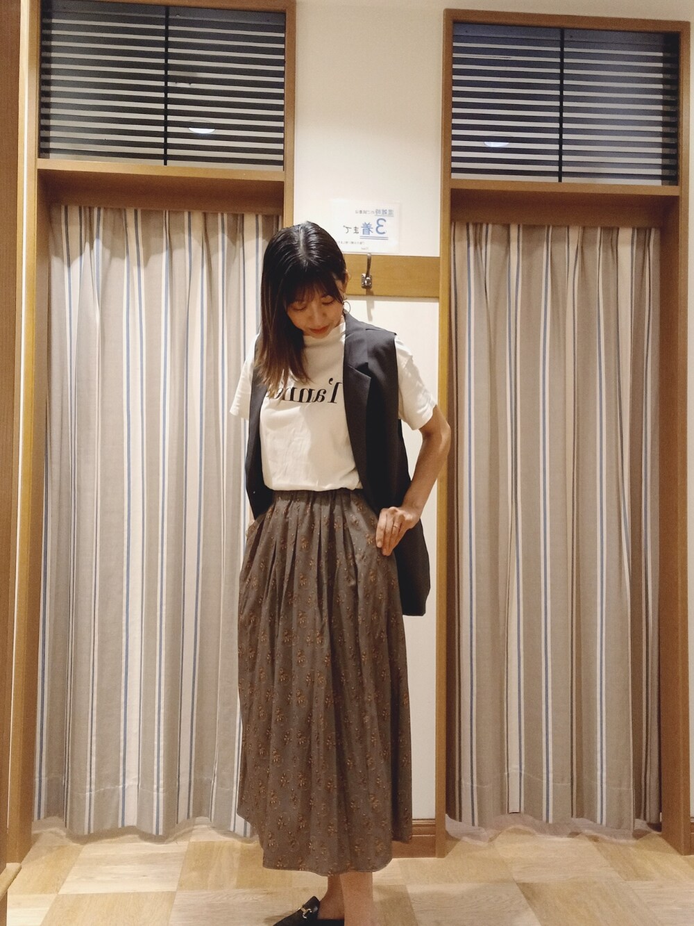 ホワイト系のTシャツ/カットソー、グレー系のノーカラージャケット、グリーン系のスカートを着用したレディースの秋コーディネートの3枚目の写真