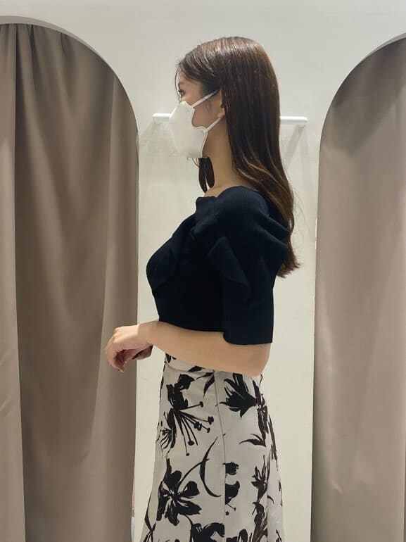 ホワイト系のスカート、ホワイト系のブーツ、ブラック系のニット/セーターを着用したレディースの夏コーディネートの5枚目の写真