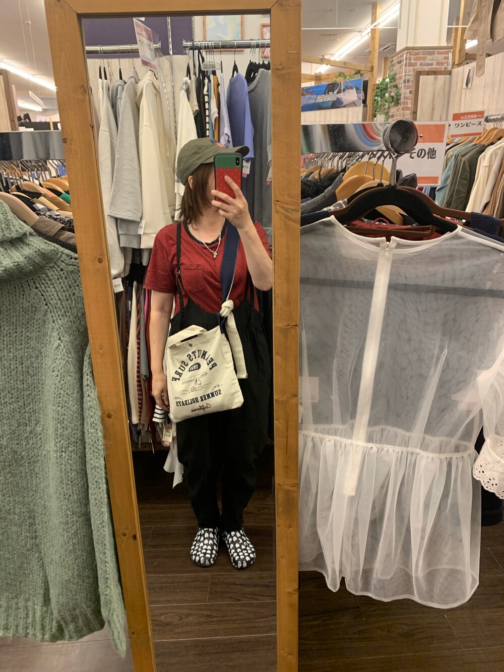 ホワイト系のショルダーバッグ、レッド系のTシャツ/カットソー、ブラック系のサロペット/オーバーオールを着用したレディースの秋コーディネートの2枚目の写真