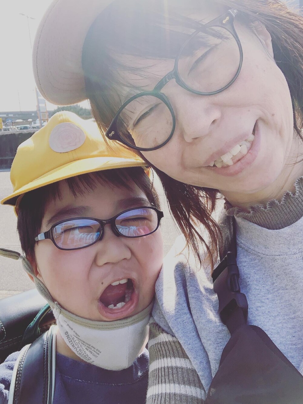 グレー系のベスト、ブルー系のデニムパンツ、ブラック系のスリッポンを着用したレディースの春コーディネートの2枚目の写真