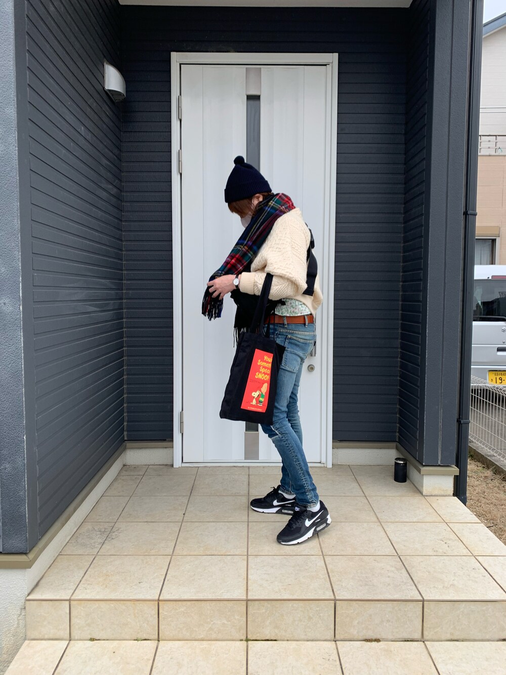 ブルー系のデニムパンツ、ブラック系のスニーカー、ブラック系のボディバッグ/ウエストポーチを着用したレディースの冬コーディネートの3枚目の写真