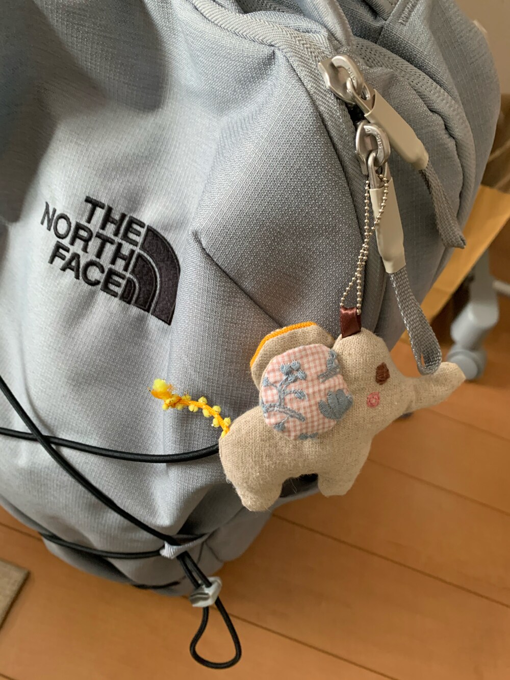 グレー系のTシャツ/カットソー、グレー系のバックパック/リュック、ブルー系のキャップを着用したレディースの夏コーディネートの3枚目の写真