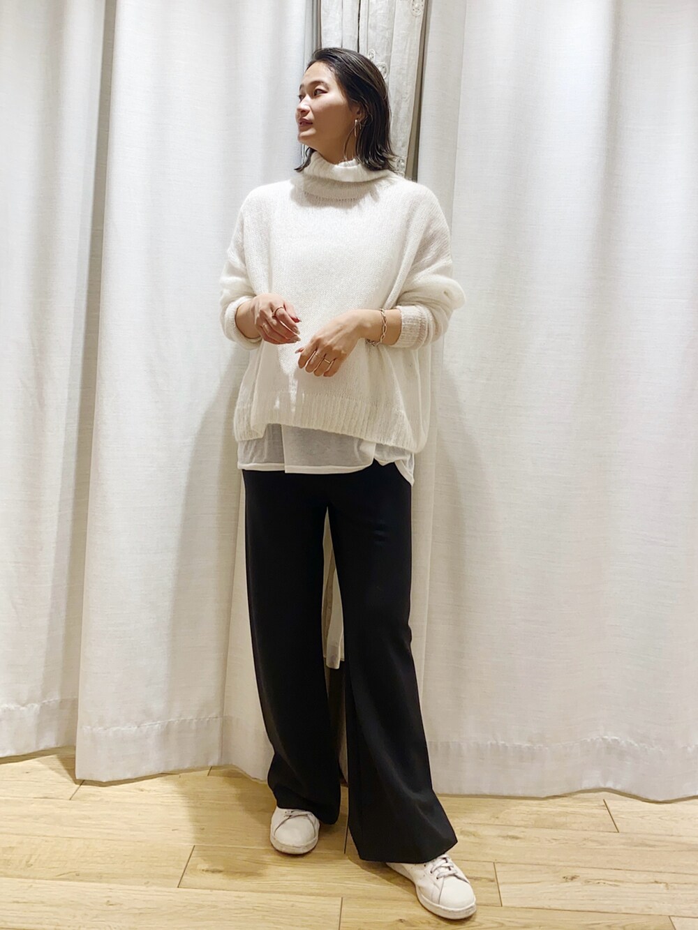 ホワイト系のニット/セーターを着用したレディースの冬コーディネートの2枚目の写真