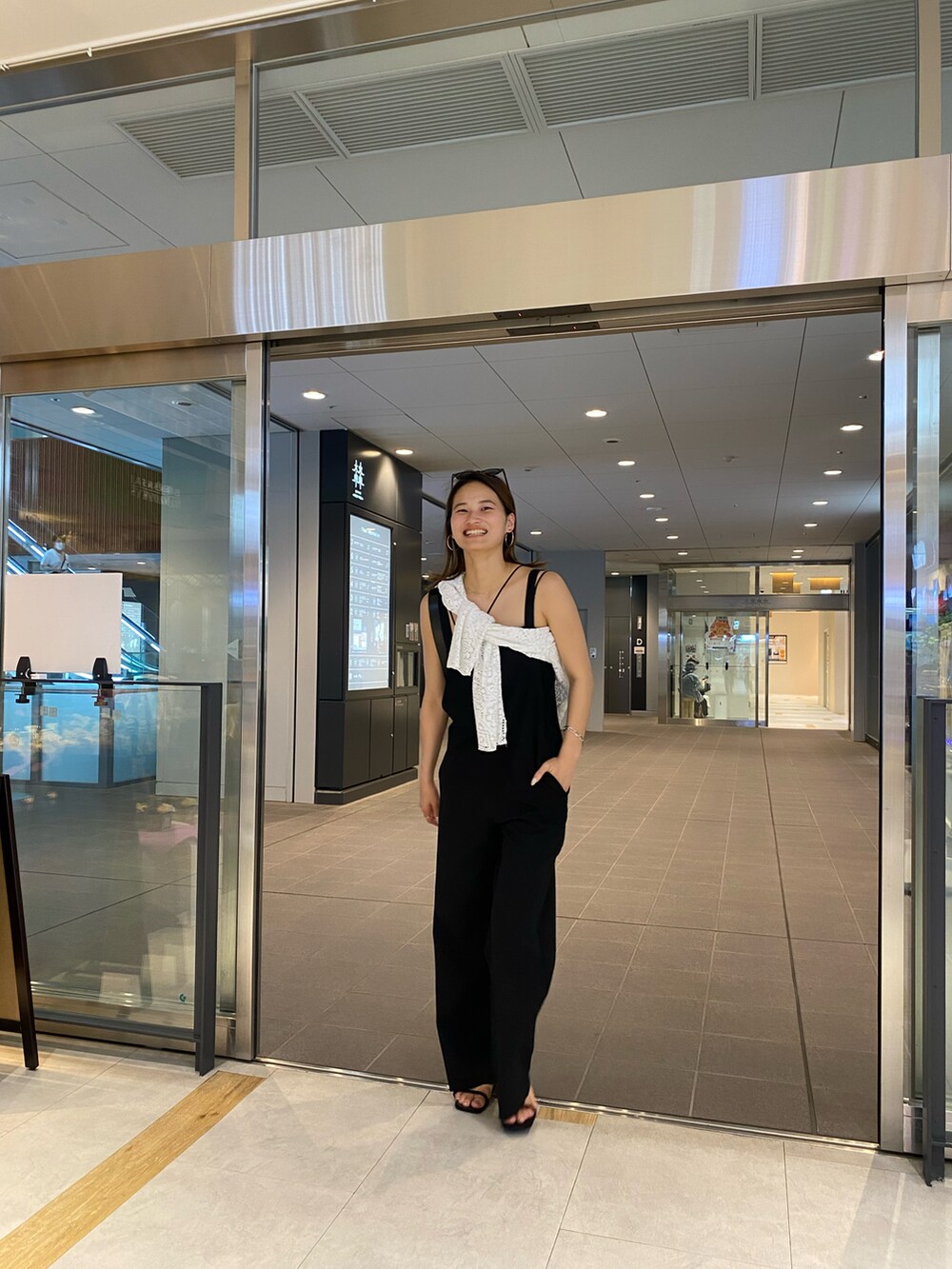 ブラック系のサンダル、ブラック系のサロペット/オーバーオールを着用したレディースの夏コーディネートの2枚目の写真